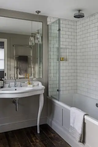 salle de bain aux designs traditionnels et porte de douche en verre
