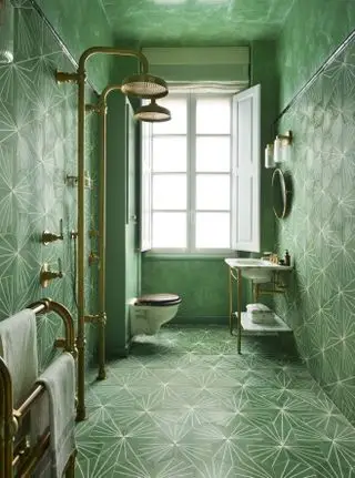 salle de bain verte avec plafond vert, carrelage à motifs, douches doubles dorées, meuble vasque, volets sur fenêtre