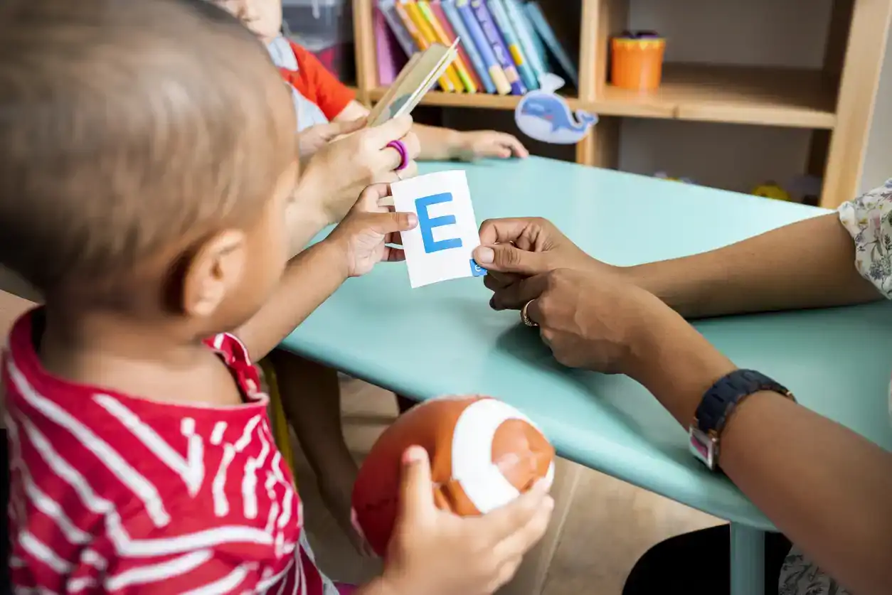 Young children learning the English alphabet with their parents stock photo