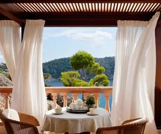 varanda com pergolado coberto e cortinas para sombra