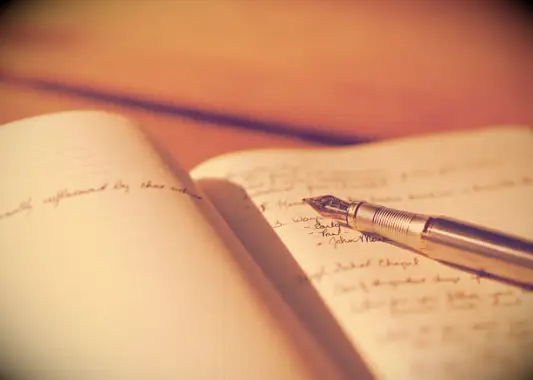 A pen resting in a notebook.