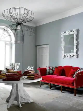 Couloir gris avec canapé rouge et plafonnier tendance