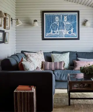 Petit salon blanc avec canapé d'angle et lambris mural