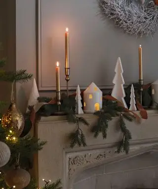 크리스마스 장식품과 나뭇잎으로 장식된 벽난로를 닫으세요