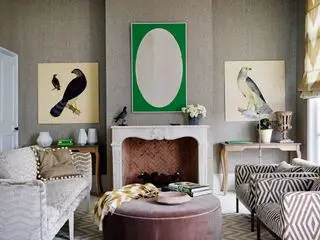 Ideen für strukturierte Tapeten in einem taupefarbenen Wohnzimmer mit grünen und weißen Akzenten, Stühlen mit geometrischem Muster und einem Steinkamin.