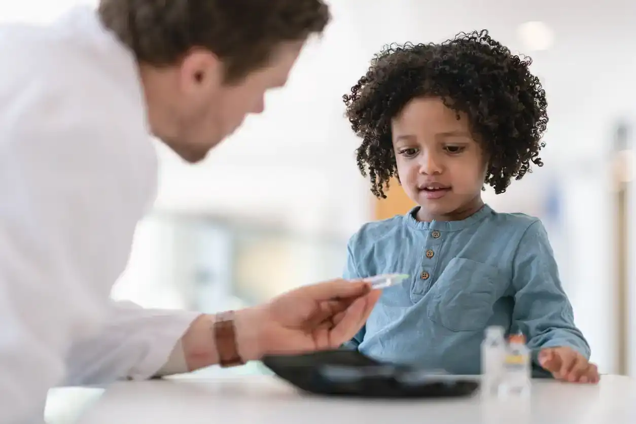 Doctor speaks to small child about growth supplement
