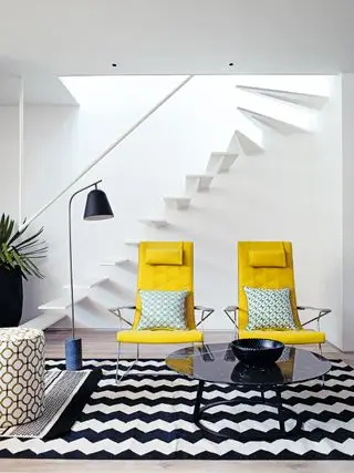 Salón en blanco y negro con sillones amarillos contemporáneos