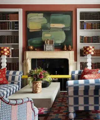 Efterårsmantelideer med brændt orange tapet, sten kaminhylde, æble- og pærepynt i træ