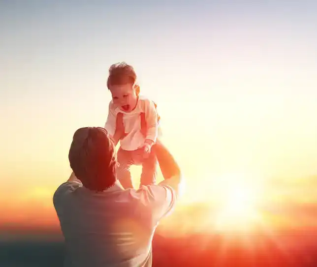 Father and his daughter baby girl playing and hugging outdoors