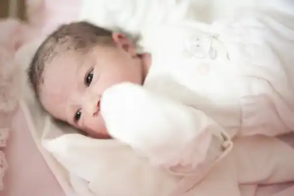 Contemplative baby girl with inspirational name looking to the left