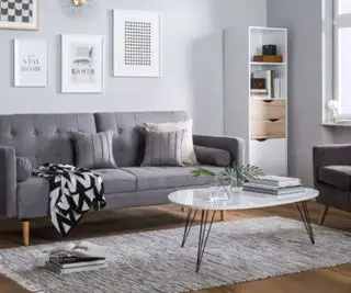 아늑한 담요와 러그를 갖춘 회색 거실입니다.