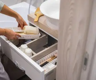 Un tiroir de salle de bain ouvert avec organisateurs