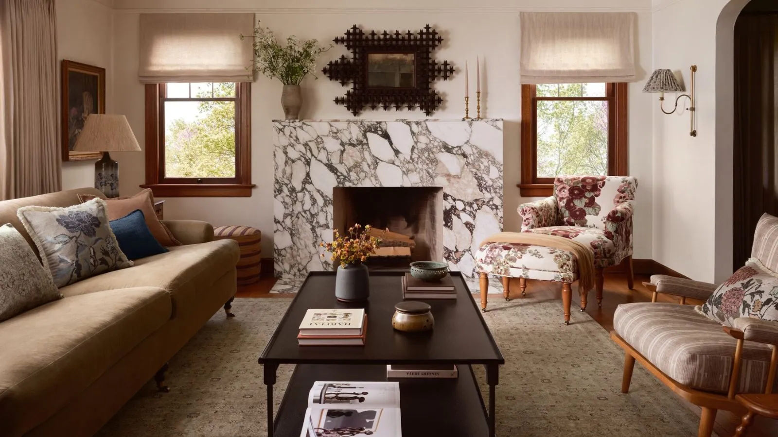 Designer Collaboration Round-Up Hero Image of the Heidi Caillier x Joon Loloi Rug Collaboration Shot i en eklektisk vintage stue med et stort tæppe og marmor pejs' loading='lazy' title=